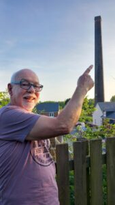 man pointing to chimney